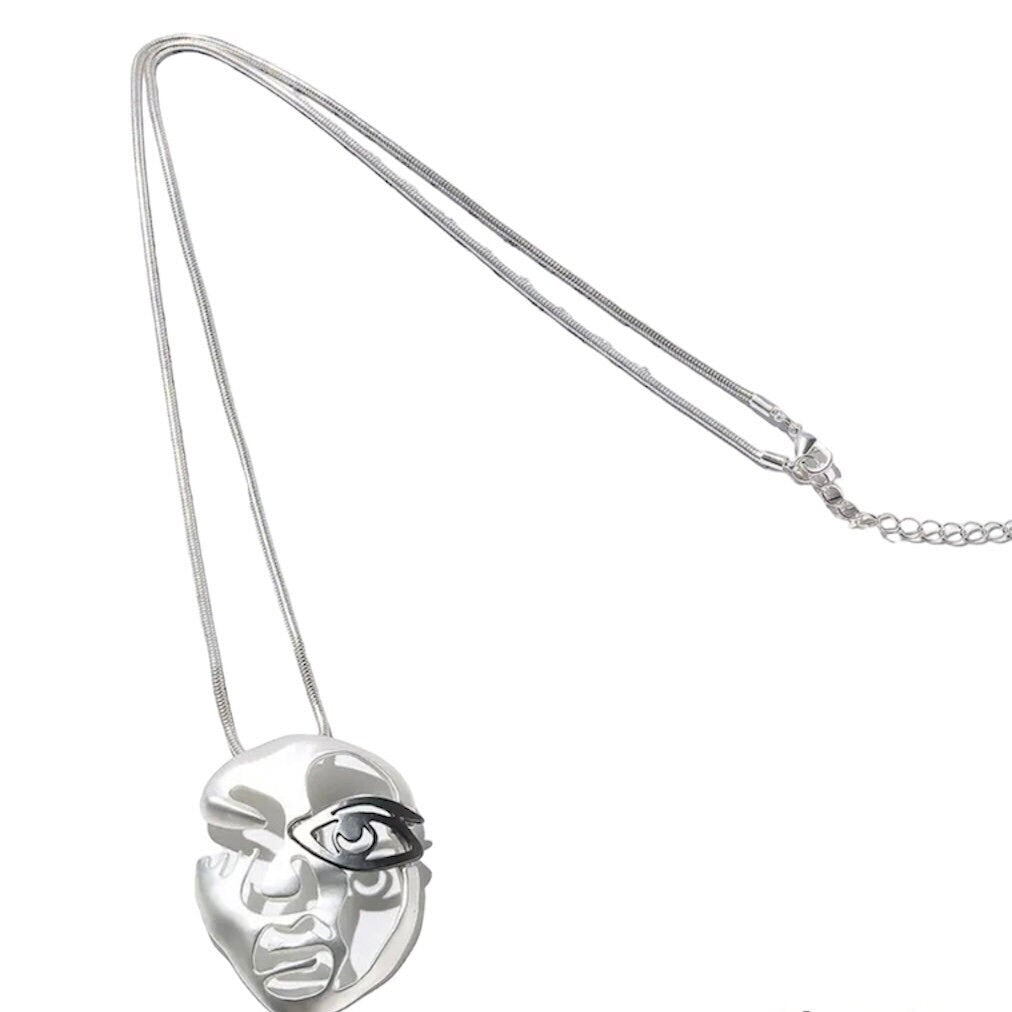 Silver Hollow Face with Black Eye Mask on a Long Silver Necklace