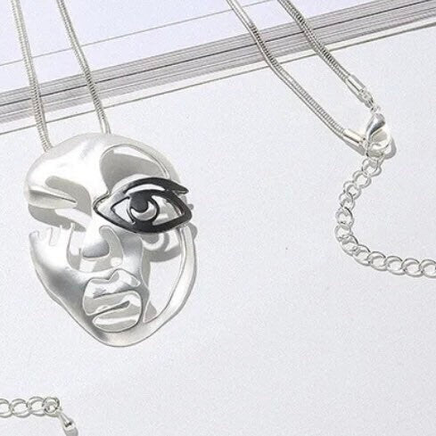 Silver Hollow Face with Black Eye Mask on a Long Silver Necklace